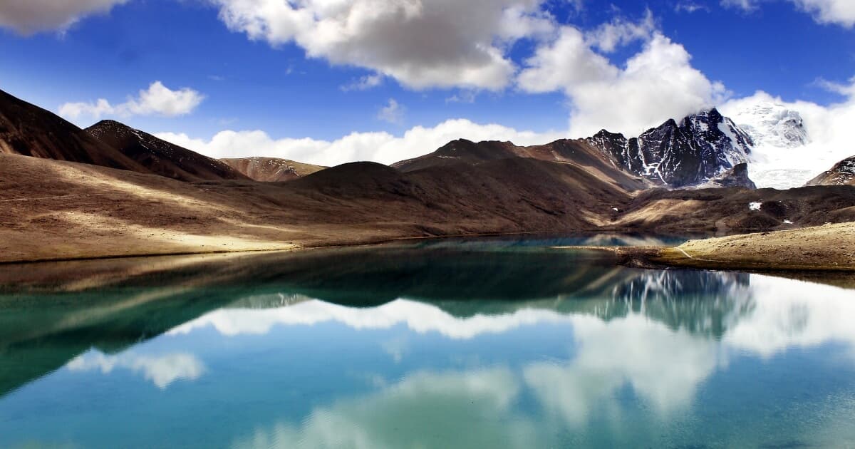 Gurudongmar Lake surrounded by snow-capped mountains in Sikkim, India